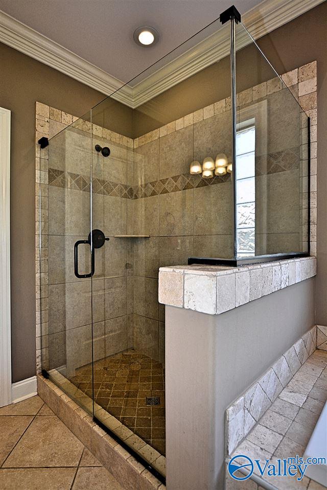 bathroom with walk in shower, tile patterned flooring, and ornamental molding