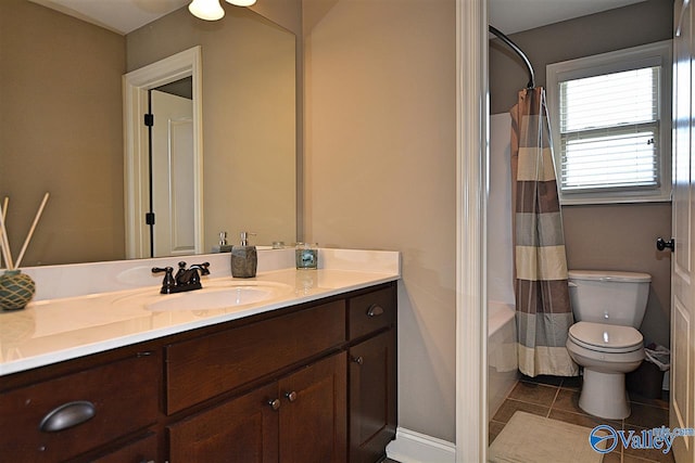 full bathroom featuring tile patterned flooring, vanity, toilet, and shower / bathtub combination with curtain