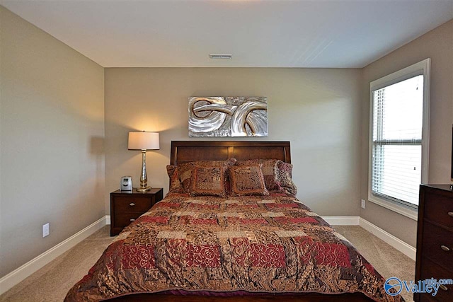 bedroom with light colored carpet