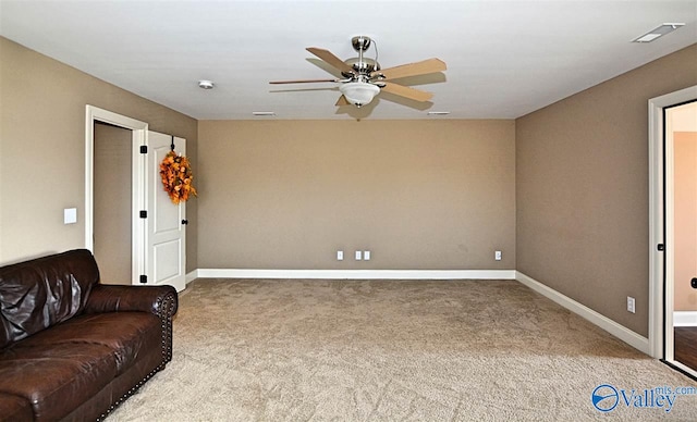 carpeted living room with ceiling fan