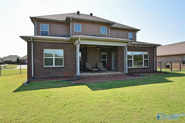 back of house featuring a patio area and a yard