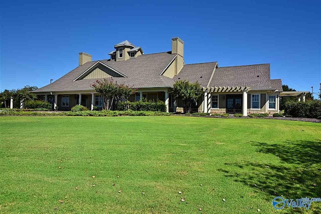 rear view of property with a yard