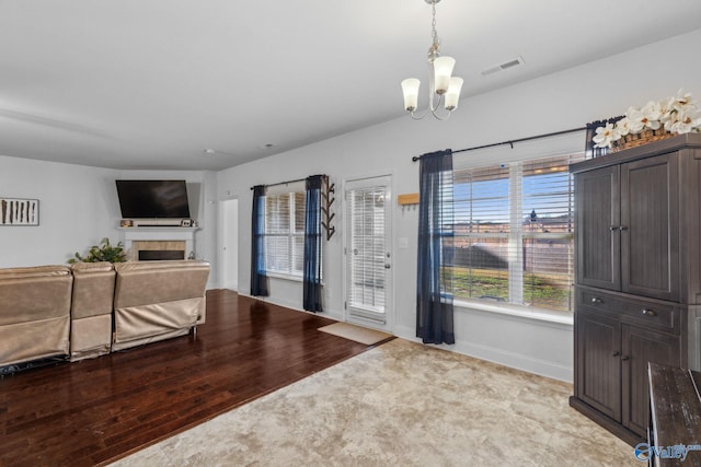 living room featuring a chandelier and light hardwood / wood-style flooring