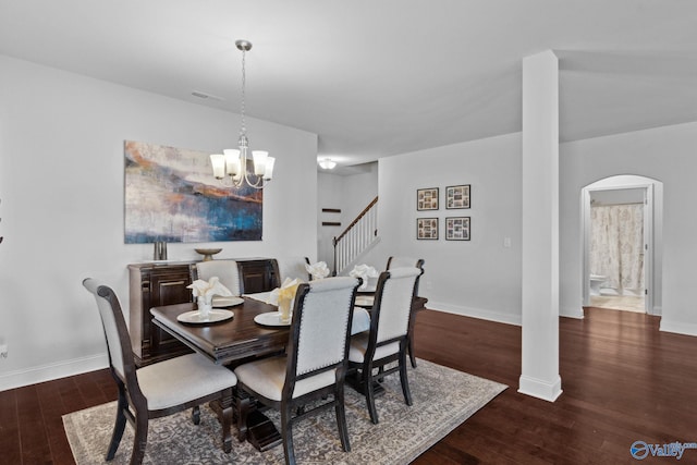 dining area with a chandelier and dark wood-type flooring