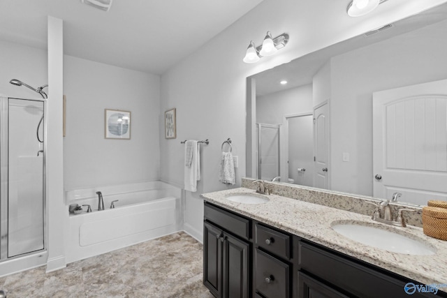 bathroom with vanity and shower with separate bathtub