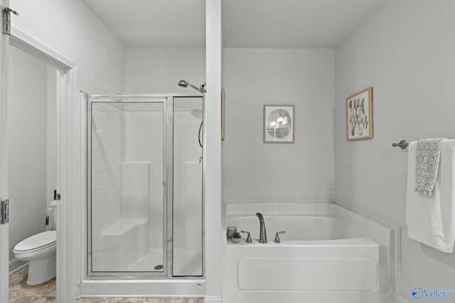 bathroom featuring separate shower and tub and toilet