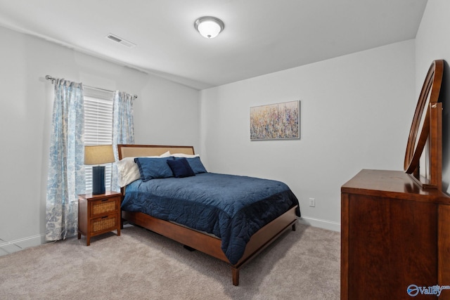 bedroom featuring light carpet