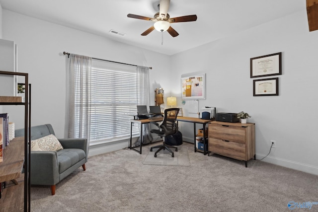 office space featuring light colored carpet and ceiling fan