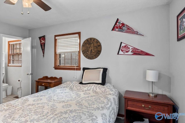 bedroom featuring connected bathroom, ceiling fan, and a textured ceiling