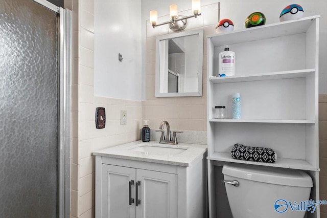 bathroom featuring vanity, toilet, and an enclosed shower