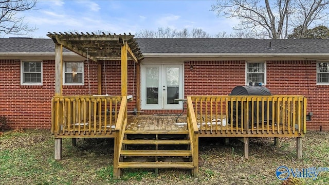 back of house featuring a wooden deck and french doors