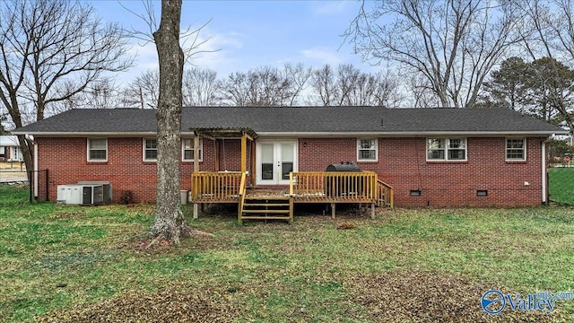 rear view of property featuring cooling unit, a yard, a wooden deck, and french doors