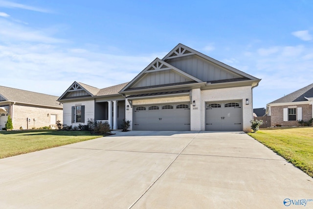 craftsman house with a garage and a front lawn