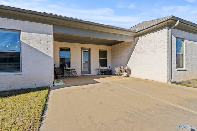 entrance to property featuring a patio area