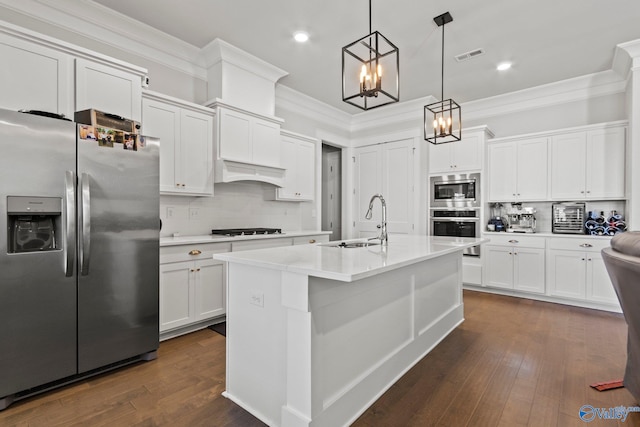 kitchen featuring white cabinetry, sink, decorative light fixtures, and stainless steel appliances