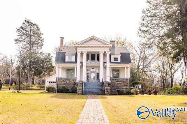 neoclassical home with a front yard