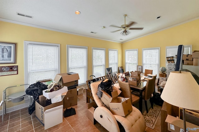 interior space featuring ceiling fan, lofted ceiling, ornamental molding, and tile patterned flooring