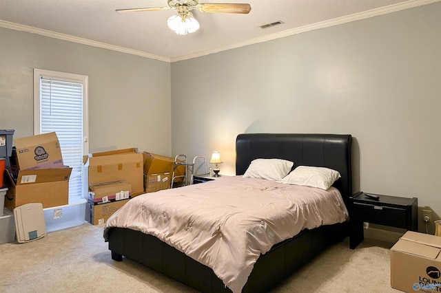 bedroom featuring light carpet, a textured ceiling, ornamental molding, and ceiling fan