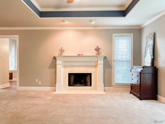 unfurnished living room with a fireplace, a raised ceiling, carpet flooring, and crown molding