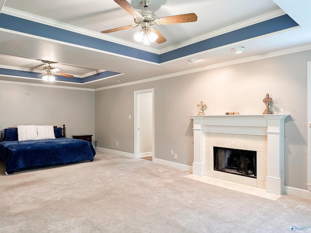 bedroom with a tray ceiling, carpet floors, baseboards, a fireplace, and ornamental molding