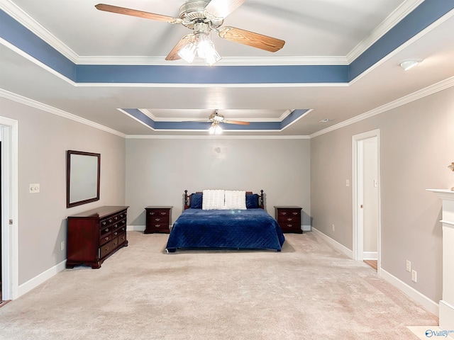 carpeted bedroom with baseboards, a ceiling fan, a tray ceiling, and crown molding