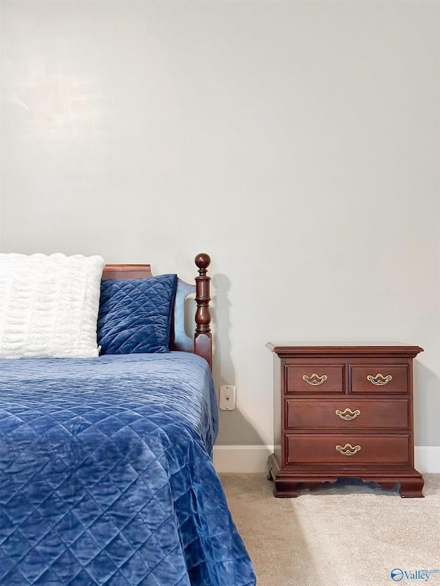 bedroom with baseboards and light colored carpet