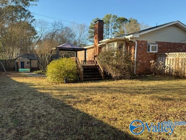 view of yard with a gazebo and a wooden deck