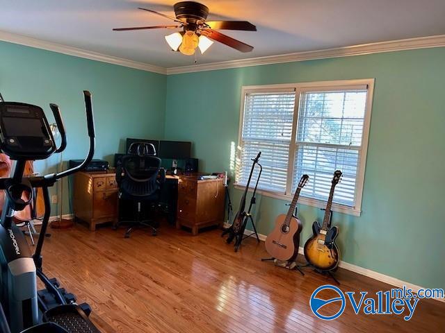 office area featuring wood-type flooring, ceiling fan, and ornamental molding