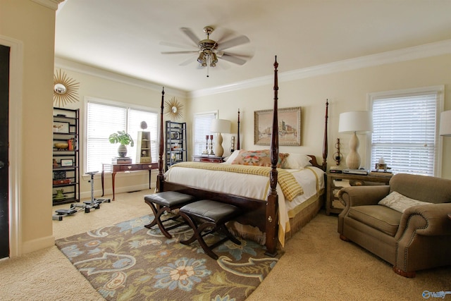 carpeted bedroom featuring ceiling fan, baseboards, and ornamental molding