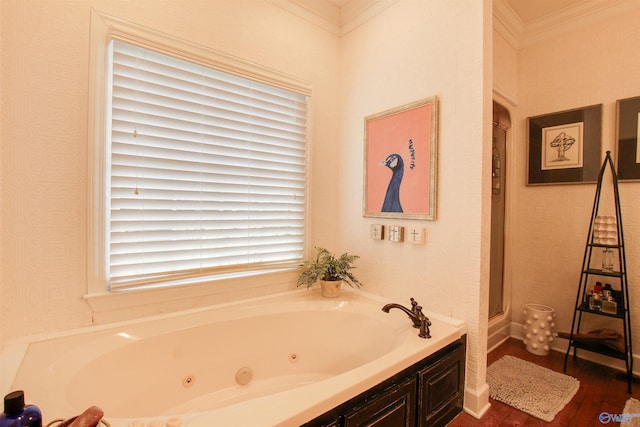 bathroom featuring a tub with jets, wood finished floors, and crown molding
