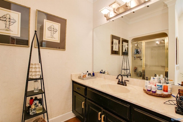 full bathroom featuring a stall shower, vanity, and ornamental molding