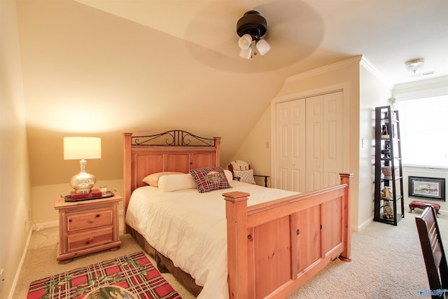 bedroom with baseboards, a closet, and light carpet