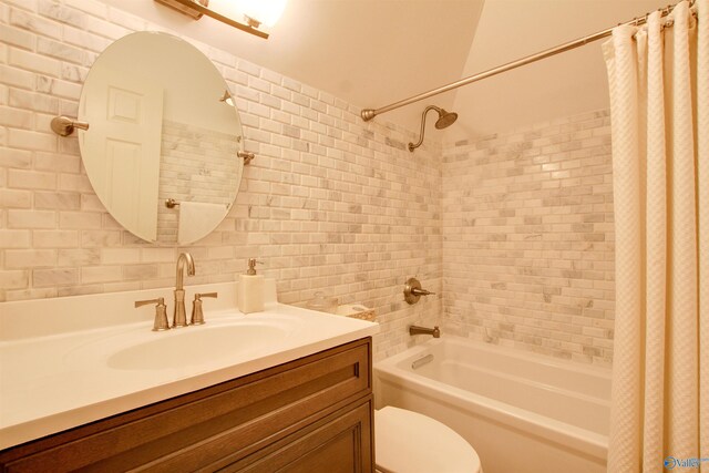 full bath featuring tasteful backsplash, tile walls, toilet, shower / bath combo, and vanity