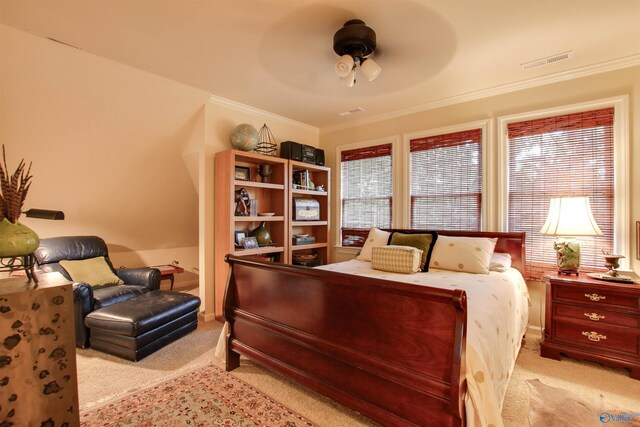 bedroom with ornamental molding, a ceiling fan, visible vents, and light carpet