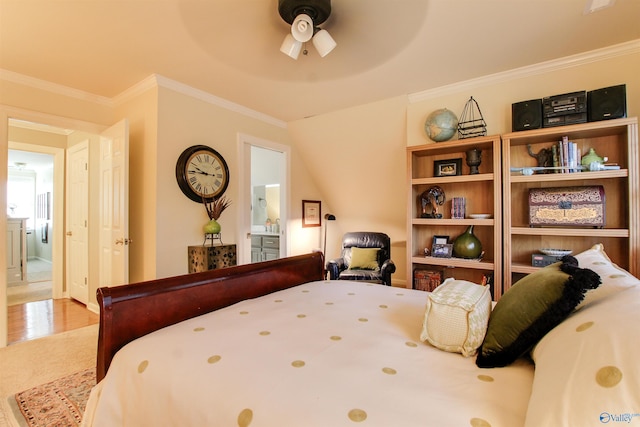 bedroom with wood finished floors and ornamental molding