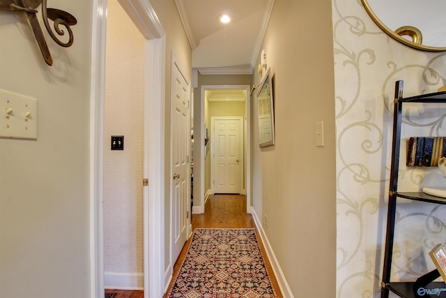 corridor with crown molding, recessed lighting, and baseboards