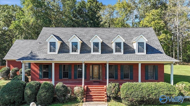 cape cod house with a porch and a front lawn