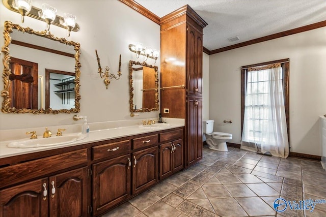 bathroom featuring tile patterned flooring, a textured ceiling, toilet, vanity, and ornamental molding