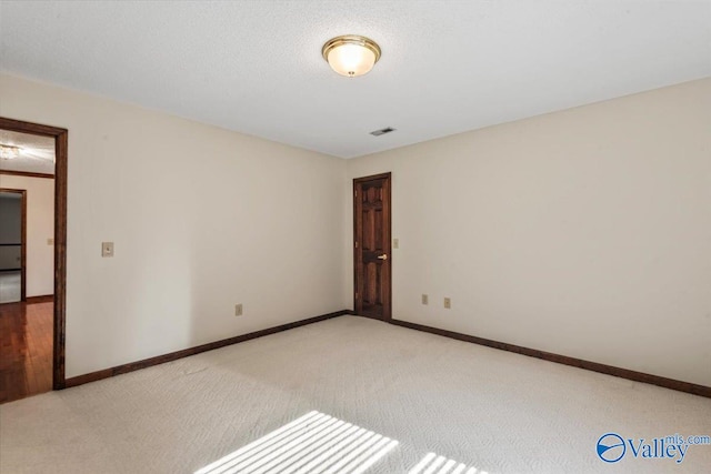 empty room featuring light colored carpet