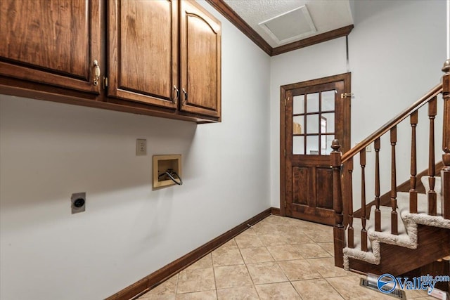 washroom with washer hookup, cabinets, hookup for an electric dryer, light tile patterned floors, and ornamental molding