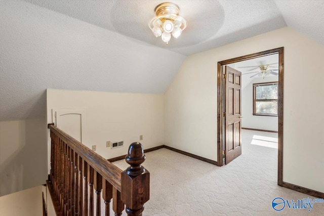 bonus room with a textured ceiling, light colored carpet, ceiling fan, and lofted ceiling