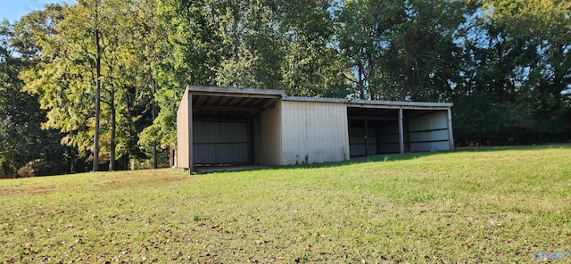 view of outbuilding featuring a lawn