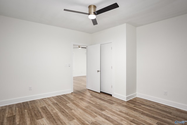 unfurnished bedroom featuring wood finished floors, baseboards, and ceiling fan