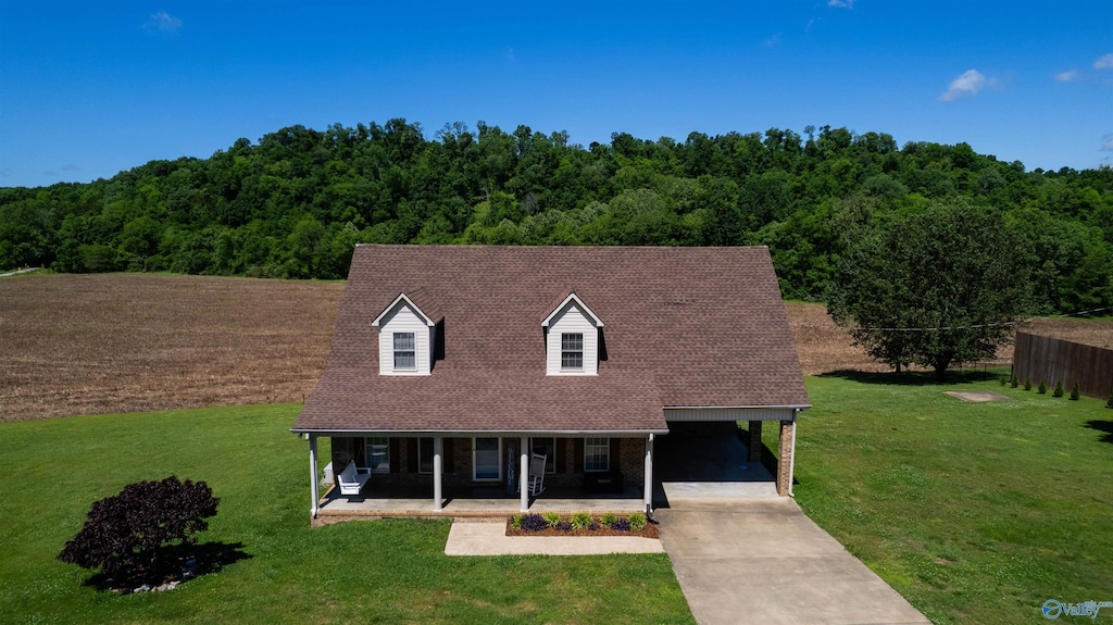 cape cod home with a carport, covered porch, and a front yard