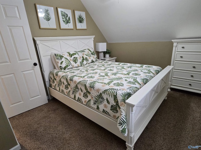 bedroom featuring lofted ceiling and dark colored carpet