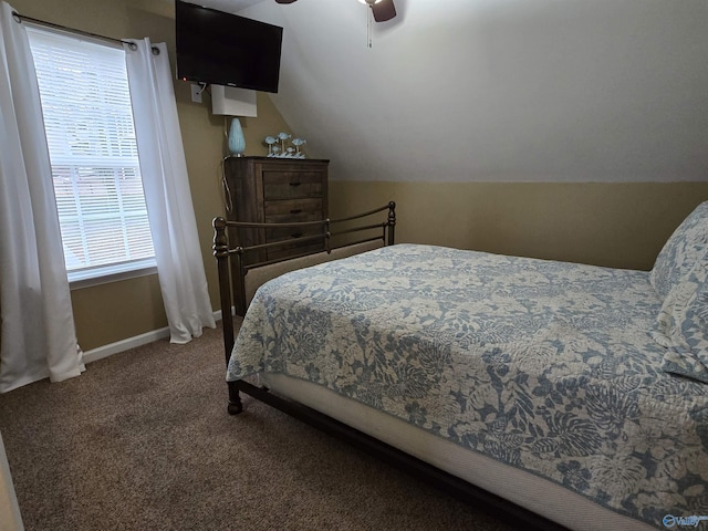 bedroom with ceiling fan, lofted ceiling, and carpet flooring