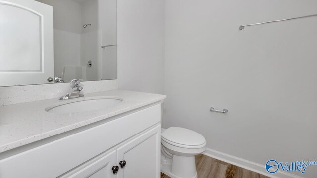 bathroom with vanity, hardwood / wood-style floors, and toilet