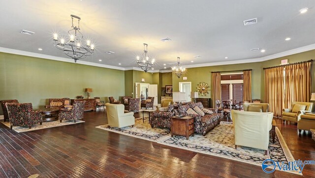 living room with crown molding, hardwood / wood-style floors, and a chandelier