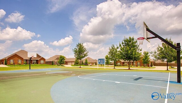 view of sport court with a yard