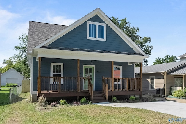 view of front of house featuring covered porch and a front lawn